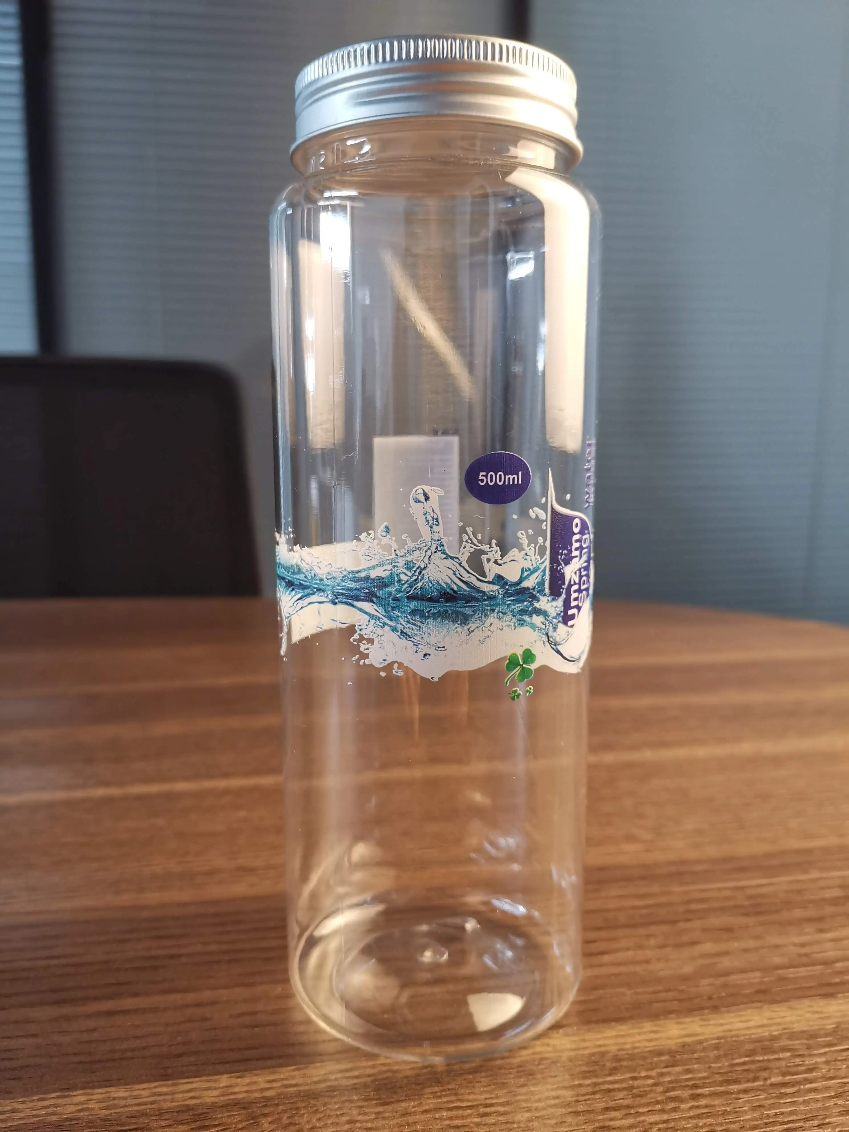Glass bottle with gloss varnish prints